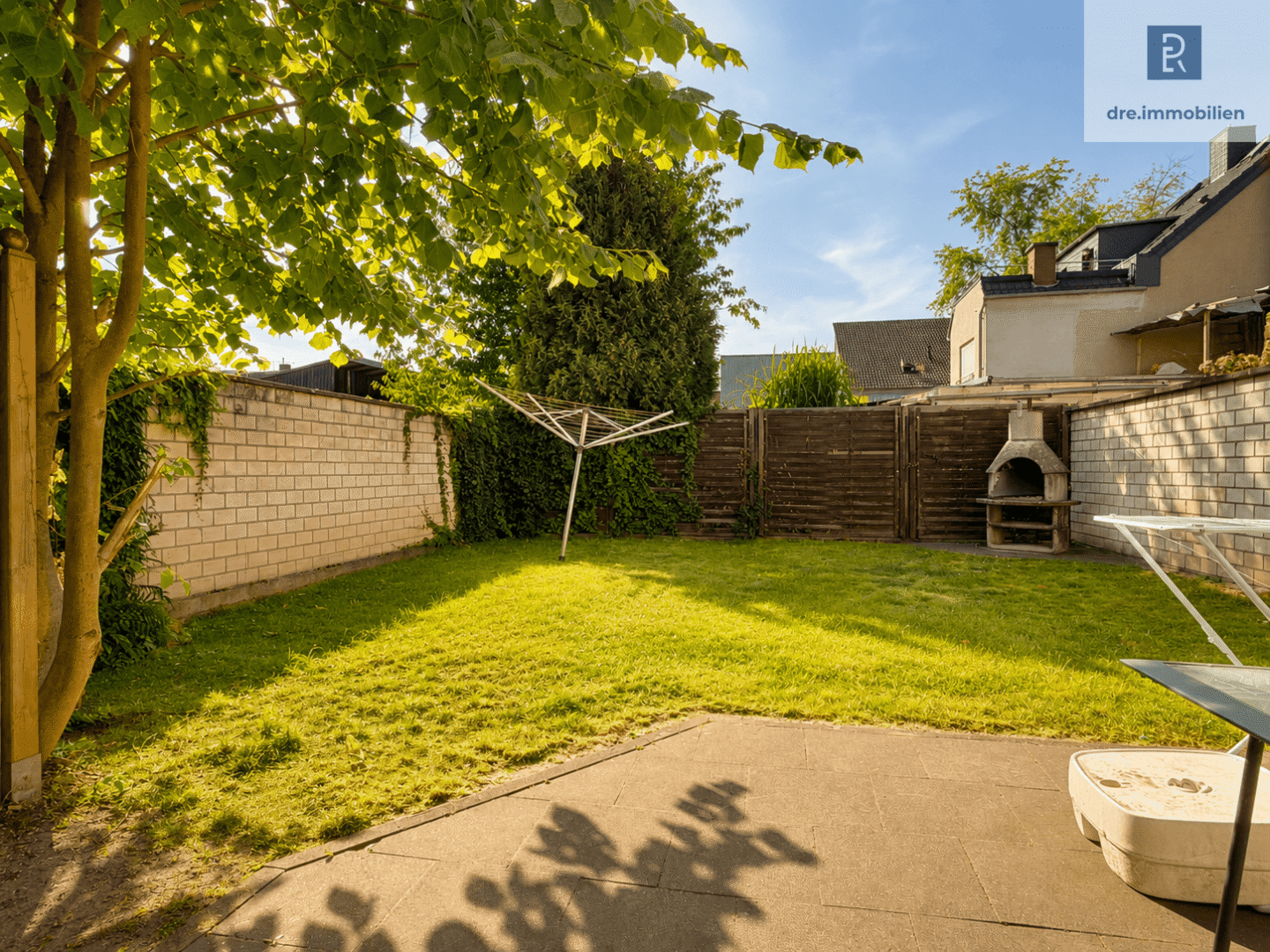 Gepflegter Garten mit Rasen und Terrasse (mit KI bearbeitet)